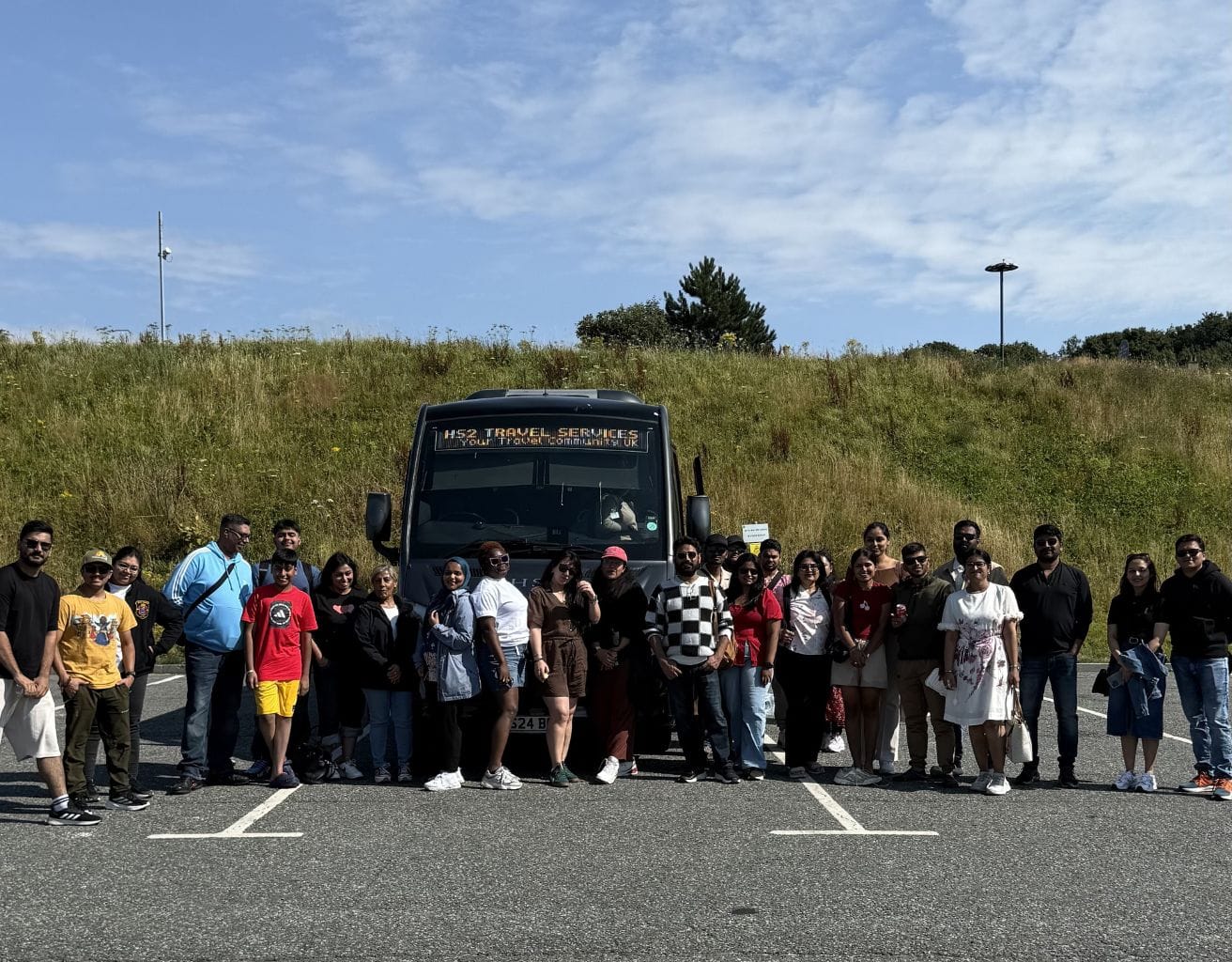Travellers near the tour bus taking a picture